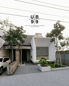 a white truck is parked in front of a house with trees and bushes on the driveway