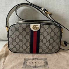 100% Authentic Gucci Small Ophidia Camera Bag In Canvas & Leather Trim. Size - 9.5”-5.75”-2.75”- Will Fit Any Phone Plus Much More. Adjustable Crossbody Strap. It Was Worn And Got A Few Marks On Bottom And Sides ( One Small Pilling On The Strap - But It’s Inside And Not Visible When The Bag Is On. A Small Stain Next To The Buckle- Last Pic. Lining Is Pretty Clean - No Stains Or Odor. Retail $1790 Plus Tax. The Bag Was Purchased At Gucci Last Year. Thank You ! Small Camera Bag, Gucci Ophidia, Bags Gucci, Small Camera, Canvas Leather, Bago, Crossbody Strap, Leather Trim, Leather Trims