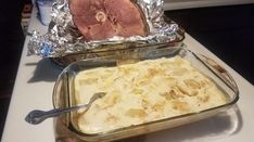 two pans filled with food sitting on top of a counter next to each other