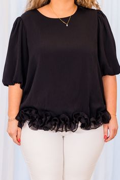 Unleash your daring side with our Soft As Down Top in Black! The spiral flounce hem and elastic bubble sleeves add a touch of boldness to this elegant and trendy piece! Take on new challenges and stand out in style! 100% Polyester Chic Ruffle Hem Blouse For Night Out, Black Blouse With Ruffle Hem For Party, Trendy Party Blouse With Ruffle Hem, Party Blouse With Ruffles And Balloon Sleeves, Black Top With Ruffle Hem And Sleeve, Party Short Sleeve Tops With Ruffle Hem, Elegant Black Top With Ruffle Hem, Elegant Black Blouse With Ruffle Hem, Spring Black Blouse With Ruffle Hem