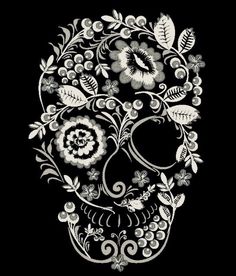 a black and white drawing of a skull with flowers