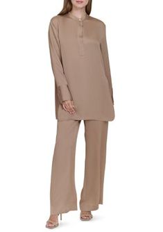 A covered mandarin collar and allover texture adds intrigue to this tunic top from HALSTON. | Halston Women's Long Sleeve Covered Placket Textured Tunic Top, Large Beige Viscose Blouse For Work, Elegant Long Sleeve Tunic For Daywear, Fall Split Neck Tunic, Long Sleeve Tunic With Placket For Work, Elegant Daywear Tunic, Elegant Spring Tunic With Split Neck, Elegant Split Neck Tunic For Spring, Elegant Split Neck Spring Tunic, Chic Beige Long Sleeve Tunic