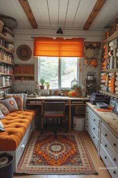 a room filled with lots of shelves and furniture next to a window covered in orange shades