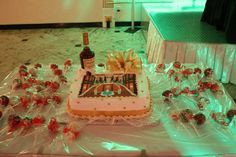 a table topped with a cake covered in frosting and candies next to a bottle of wine