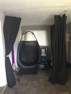 a living room with black drapes and curtains