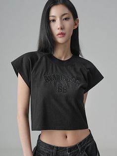 This product captivates with its vintage-inspired graphic, offering a nod to retro sportswear within a contemporary cropped tee. The embossed detail on the front panel adds a tactile dimension to the garment. Ideal for casual outings, this tee pairs effortlessly with a range of bottoms, making it a staple for any wardrobe seeking a touch of nostalgia. - This cropped tee boasts an embossed logo for a subtle yet impactful statement piece.- The classic crew neckline and short sleeves maintain a casual, comfortable fit for everyday wear.- Its cropped length offers a trendy edge, perfect for creating modern layered looks.- Designed with a nod to vintage sportswear, it infuses a retro vibe into a contemporary wardrobe. Retro Sportswear, Contemporary Wardrobe, Vintage Sportswear, Cropped Tee, Layered Look, Retro Vibe, Embossed Logo, Crop Tee, Crew Neckline