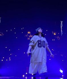 a man standing on top of a stage wearing a jersey