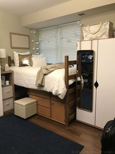 a bed sitting on top of a wooden dresser next to a window