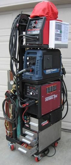 an image of a machine that is sitting on the ground in front of a garage