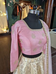 Beautiful pastel pink rawsilk blouse with hand embroidery. Sleeve length can be customised upon request. full flared brocade skirt with lining. soft net dupatta The dress will be made to order in your size. I'll send you a measurement sheet once you order for the measurements. Please convo me if you have any questions or need any customisation. Pink Raw Silk Blouse Piece For Reception, Pink Raw Silk Blouse Piece With Intricate Embroidery, Gold Banarasi Silk Choli With Intricate Embroidery, Pink Raw Silk Gown With Zari Work, Elegant Pink Banarasi Silk Lehenga, Designer Pink Brocade Lehenga, Designer Gold Anarkali Set In Brocade, Tissue Silk Lehenga With Gold Embroidery For Festivals, Gold Raw Silk Gown With Cutdana