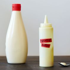 a bottle of mayonnaise next to a spoon