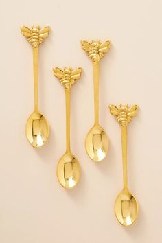 three gold spoons with dragonflies on them