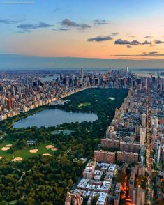 an aerial view of new york city with the central park in the foreground at sunset