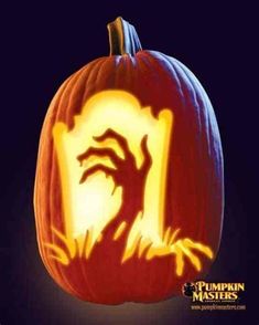 a pumpkin carved to look like a hand coming out of it