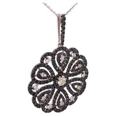 This 7.84 Carat one of a kind pendant showcases a beautiful contrast of black and white diamonds set on 18K white gold. The pendant combines a versatile modern and classic design that can be worn for any occasion. The pendant is accompanied by a 23.6 inches white gold necklace. Jewel Details: 7.84 Total Carat Weight Center Diamond- 0.63 Carat H/ VS Side Diamonds- 7.21 Black and White diamonds White diamonds are E-F/ VVS 18K White Gold White Gold Necklace, White Gold Necklaces, Black Diamonds, Moon Pendant, Flower Pendant, White Diamonds, Black Diamond, Diamond White, Classic Design