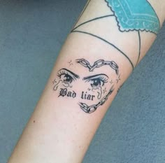 a woman's arm with a tattoo on it that reads, bad lier