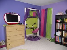 a bedroom with purple walls and green curtains