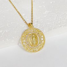 Experience the power of faith and divine protection under the devotional protection of the Blessed Virgin Mary. The Virgin Mary will always watch over and protect you, and you will be inspired and empowered. The Religious Virgin Mary Gold Virgencita Necklace is displayed with beautiful attention to detail. The pendant has a beautifully designed texture that makes the image come out and has everything you would want in a Virgin Mary Virgencita Necklace. Make a statement and show your devotion wit Spiritual Jewelry With Miraculous Medal As Gift, Spiritual Round Medallion Necklace With Adjustable Chain, Spiritual Pendant Medallion Necklace With Adjustable Chain, Gold Spiritual Jewelry And Charms For Blessing, Spiritual Necklace With Coin Pendant For Blessing, Spiritual Our Lady Of Guadalupe Pendant Necklace, Spiritual Blessing Necklaces With Coin Pendant, Spiritual Coin Pendant Necklace For Blessing, Adjustable Spiritual Medallion Jewelry