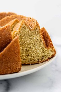 a bundt cake on a plate with one slice cut out