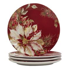 three plates with holly and poinsettia designs on them, one is red