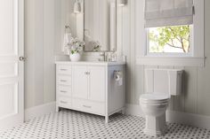 a white bathroom with a toilet, sink and mirror