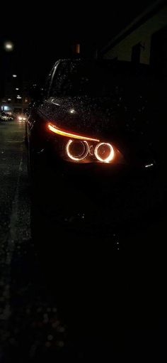 the headlights of a car are glowing in the dark