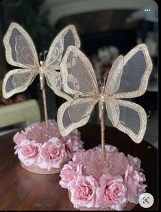 there are two decorative butterflies on the table