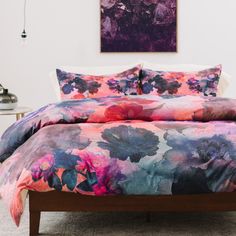 a bed with purple and pink flowers on it