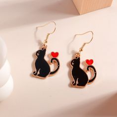 Black Cat With Heart Dangle Earrings. Perfect Gift For The Cat Lover. New In Package. Measures About 1". Black Metal Earrings For Valentine's Day, Trendy Black Heart Earrings For Gift, Trendy Black Jewelry With Cat Design, Black Heart Earrings As A Gift, Black Heart Earrings For Pierced Ears As Gift, Trendy Black Metal Heart Earrings, Black Metal Heart Earrings, Black Metal Heart Earrings For Party, Cute Black Dangle Jewelry