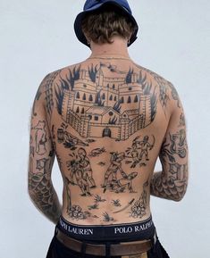 a man with many tattoos on his back