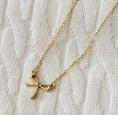 This tiny gold bow necklace is so cute and trendy.  It's the perfect dainty, minimalist jewelry!   Chain is adjustable from 15" - 18". Chic Gold Necklace With Bow, Minimalist Gold Jewelry With Bow, Dainty Adjustable Bow Necklace, Dainty Adjustable Necklaces With Bow, Dainty Adjustable Necklace With Bow, Trendy Bows, Delicate Gold Necklace, Jewelry Chain, Bow Necklace