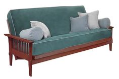 a green couch with several pillows on it and a wooden frame around the armrests