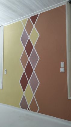 the wall is painted with different colors and shapes