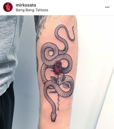 a man's arm with a snake and rose tattoo design on the left forearm