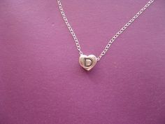 "Personalized Necklace, Heart Charm Necklace, Letter D Charm Initial Heart Shaped Pendant Necklace Cute, sweet and dainty letter \"D\" engraved on a heart! The pendant is solid sterling silver and comes with a high quality  sterling silver  16 1/2 inch chain. The chain can be ordered in 18 inch, at no extra cost, please convo me with any size adjustment requests. Please convo me with any questions. Have a great day xoxox, Hearts and Candy P.S. Please check my other items: http://www.etsy.com/shop/HeartsandCandy facebook:  https://www.facebook.com/HeartsandCandy Thnx!!" Necklace Initial Letter D, D Initial Necklace, D Necklace, Heart Charm Necklace, Heart Shaped Pendant Necklace, Heart Shaped Pendant, Initial D, Necklace Cute, White Gold Chains