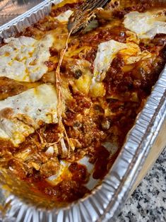 a casserole dish with meat, cheese and sauce