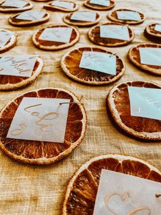 orange slices are arranged on a table with place cards for guests to write their names