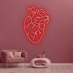 a neon heart sign on the wall next to a chair