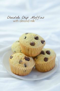 three chocolate chip muffins on a white plate with the words chocolate chip muffins with almond milk