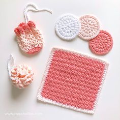 crocheted items are displayed on a white surface, including a pink square and two round ones