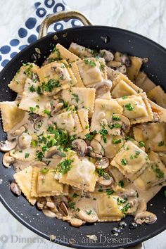 a skillet filled with ravioli and mushrooms