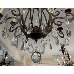 a chandelier hanging from the ceiling in a room with lights and chandeliers