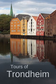 there are many different colored buildings on the water and one is in front of them