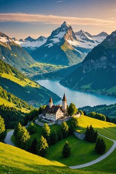 an old church in the middle of a green valley with mountains and lakes behind it