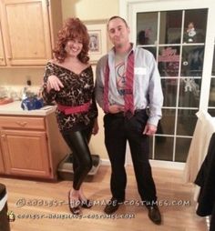 a man and woman standing in a kitchen next to each other, posing for the camera