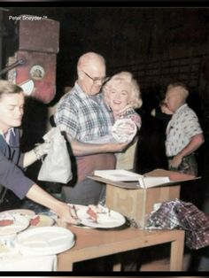 an old black and white photo of people at a table