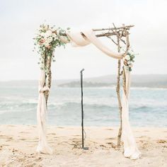 an outdoor wedding ceremony setup on the beach