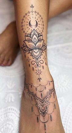 a woman's foot with a tattoo design on the top and bottom of it