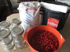 some raspberries are sitting on a table next to the canisters and bags