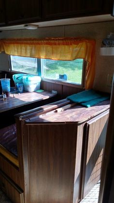 the inside of a camper with two beds and a table